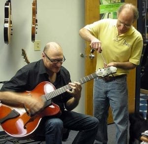 Bob Benedetto tunes John Eubank’s guitar April 2011