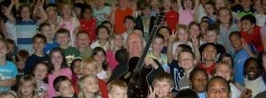 Guitarist Bill Neale with school children