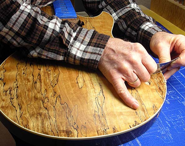 Bob Benedetto scrapes the re-curve of a Spalted Alder Custom BENNY. (Courtesy Benedetto Guitars)