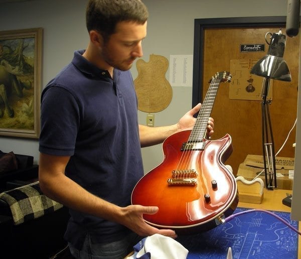 Master Luthier Damon Mailand inspects a Violinburst BENNY (Serial #S2122) (Courtesy Benedetto Guitars)