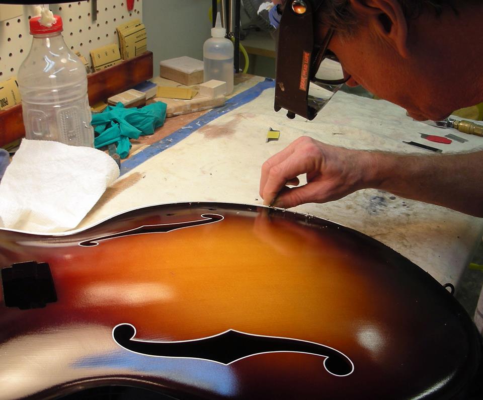 Master Finisher Larry Perkins scraping binding on a Flagship AMERICANA model. (Courtesy Benedetto Guitars)