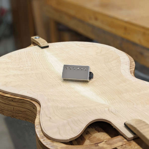 A-6 Chrome Pickup sitting on unfinished guitar body