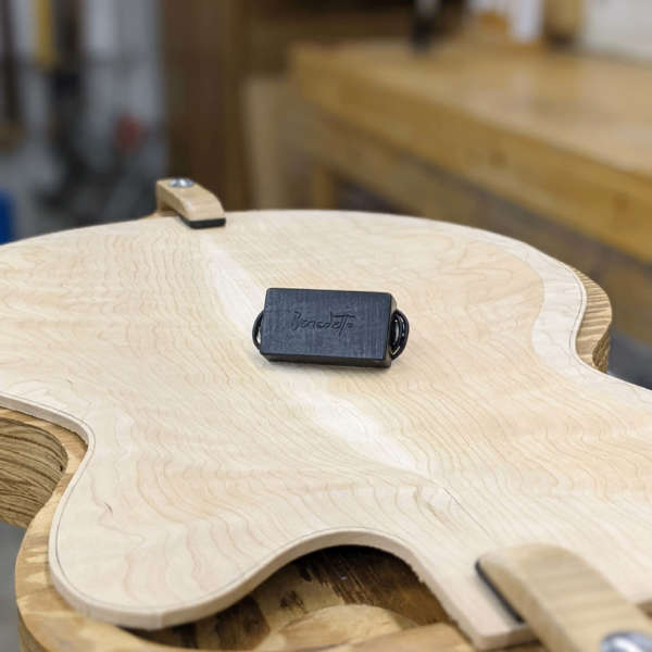 B-6 pickup resting on unfinished guitar body