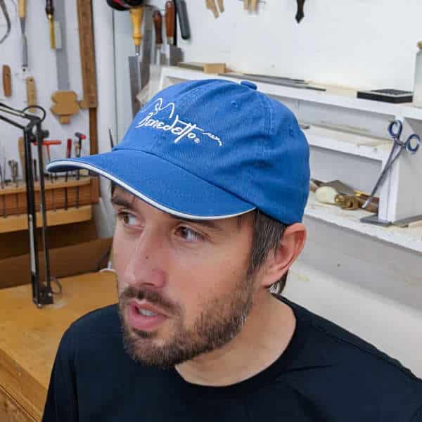 Man wearing blue Benedetto ball cap
