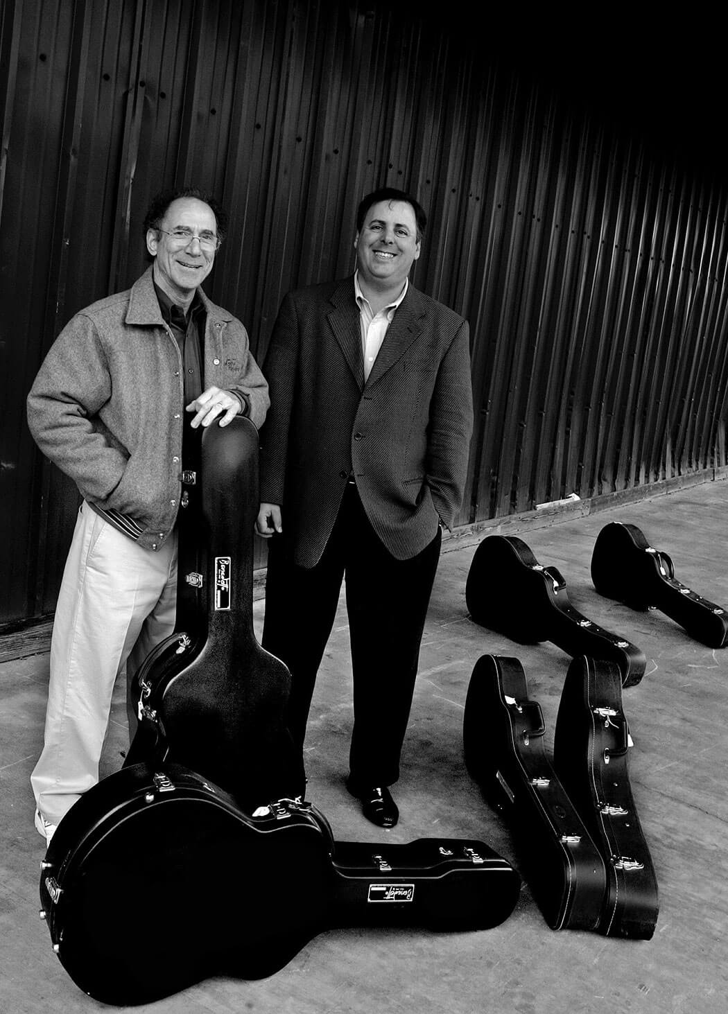 Robert Benedetto and Howard Paul stand amongst many Benedetto Guitars
