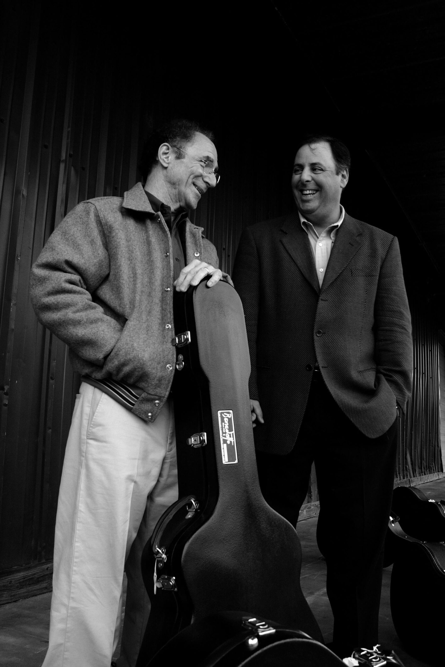 Howard Paul and Robert Benedetto enjoying a laugh in black and white
