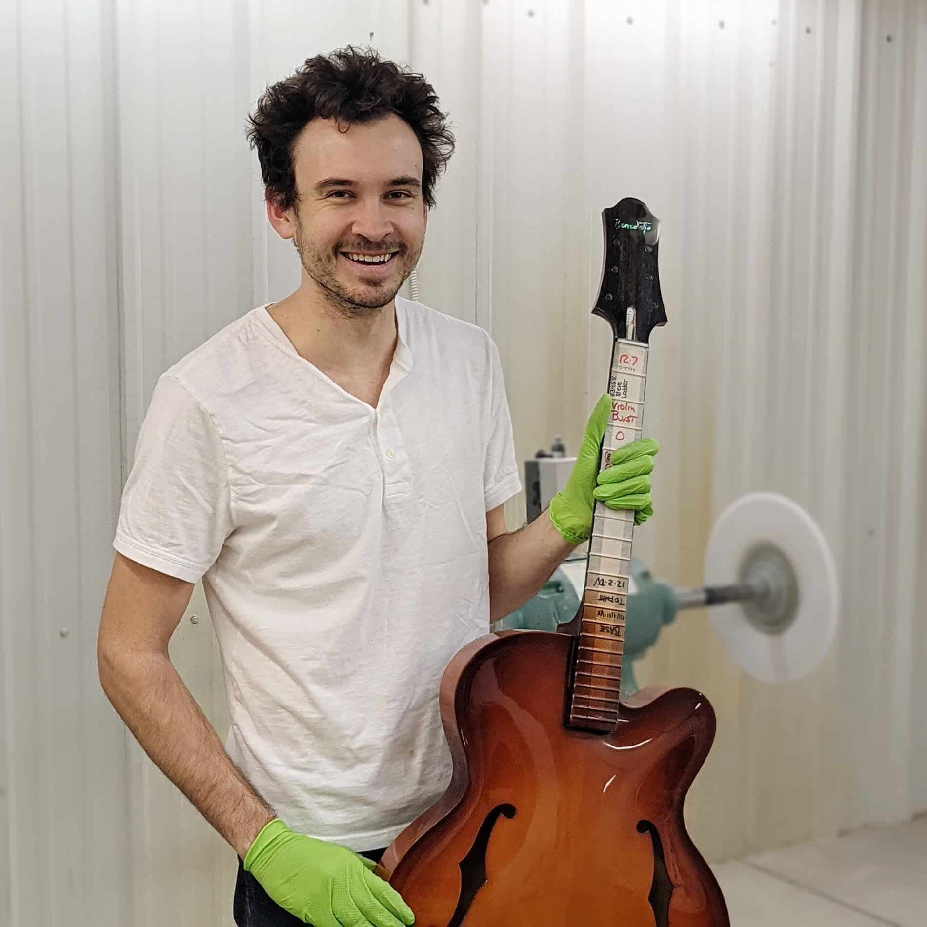 Dylan Kennedy buffing a Benedetto Guitar body.