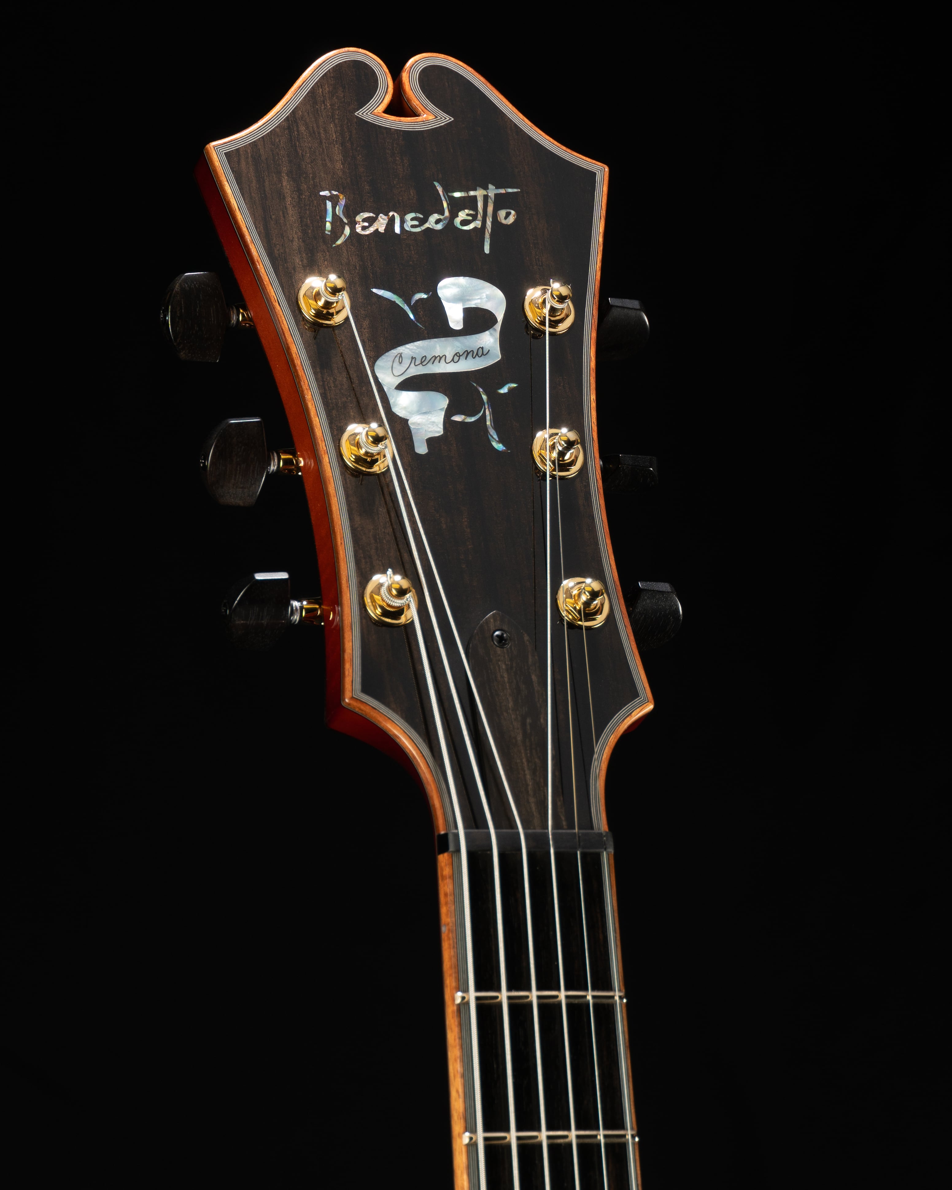 Benedetto Cremona guitar headstock with intricate inlay, showcasing craftsmanship and design details.
