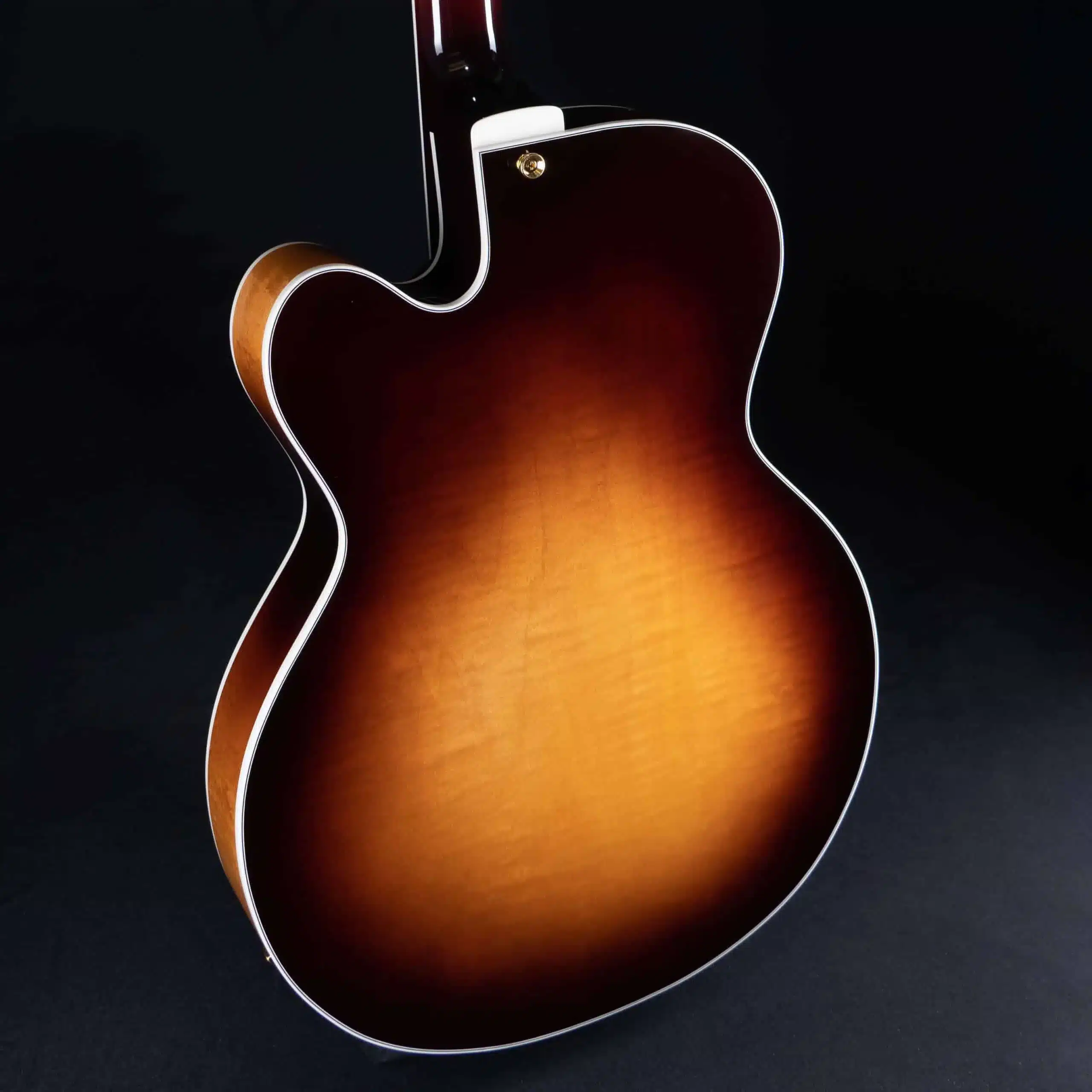 Rear view of a Benedetto Bravo archtop guitar showcasing a flamed maple body with a sunburst finish.