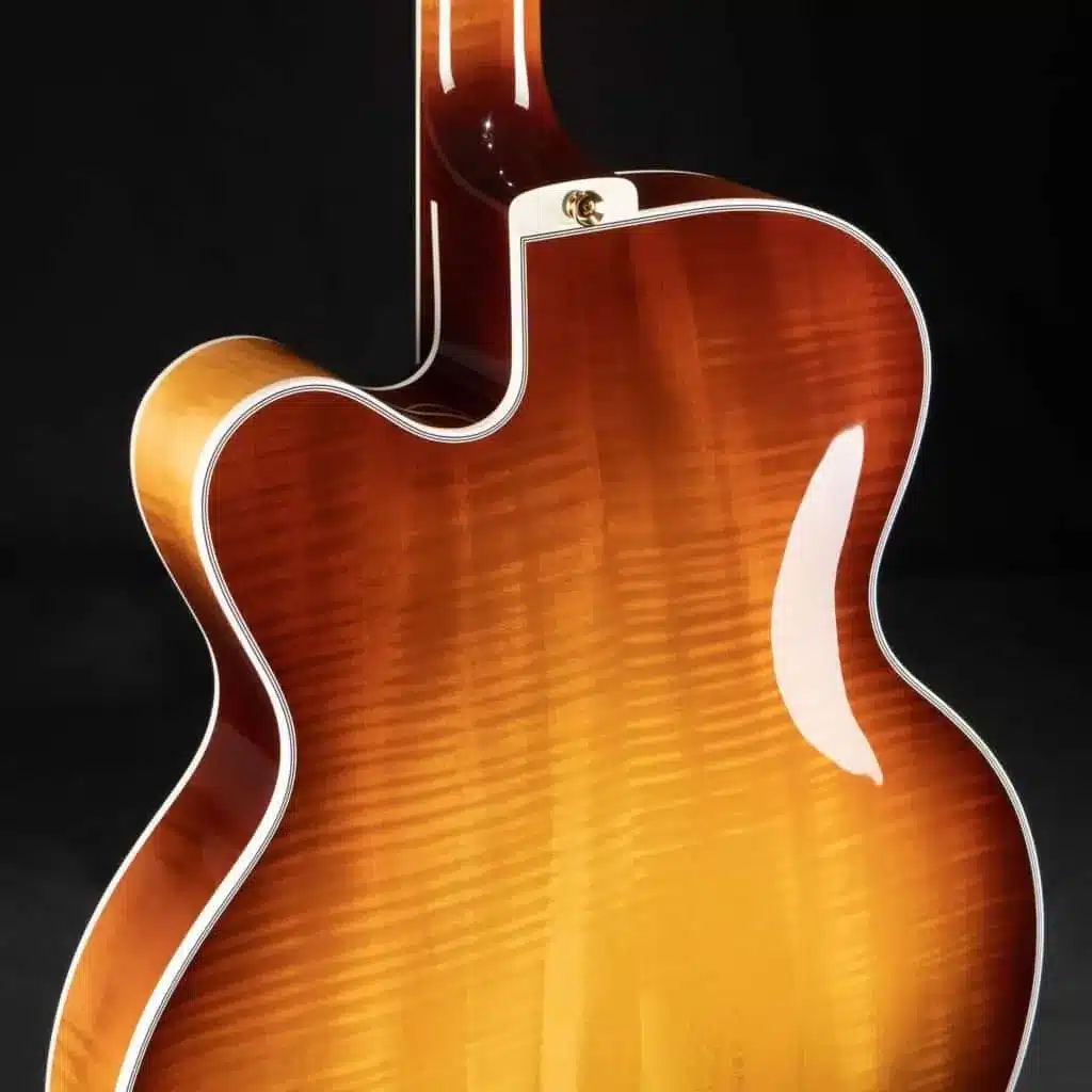 Benedetto archtop guitar body showcasing flush binding and meticulous finish application.