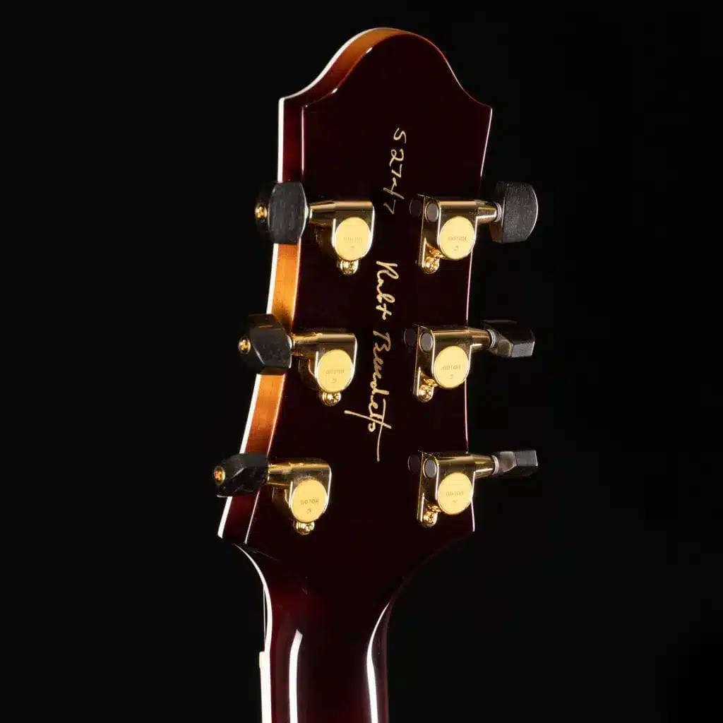 Rear view of a Benedetto guitar headstock featuring gold Gotoh tuners and Robert Benedetto's signature.